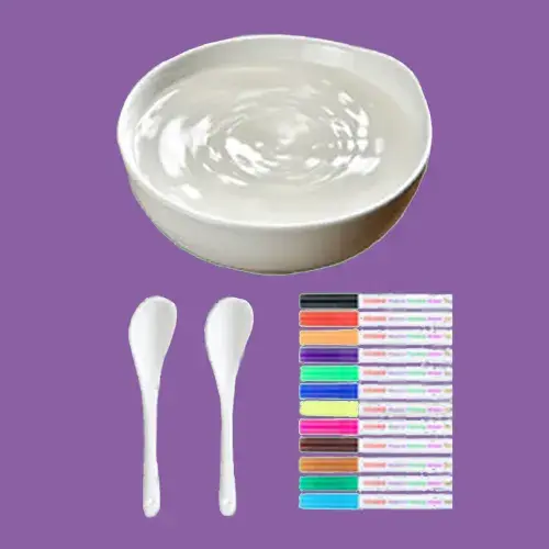 A bowl of yogurt, two spoons, and colorful markers on a purple background.