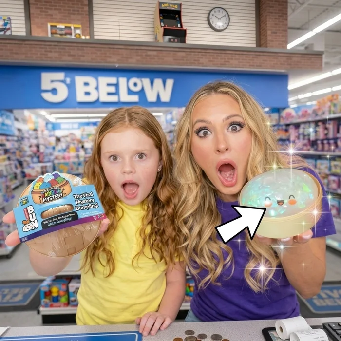 A woman and a young girl stand in a 5 Below store, looking surprised while holding up toys.
