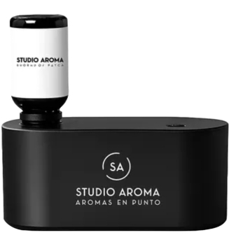 Black aroma diffuser with 'Studio Aroma' text and a white bottle on top.
