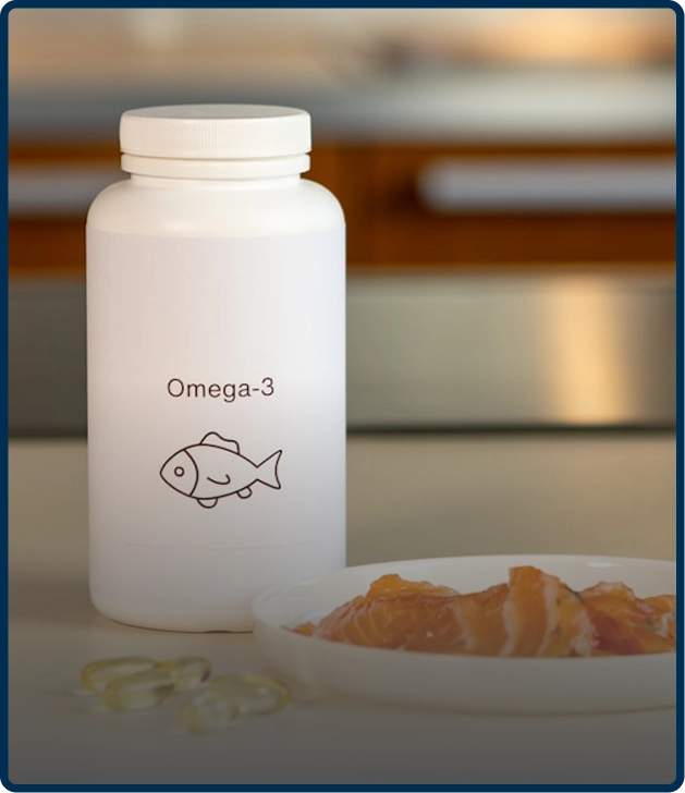White Omega-3 bottle with fish icon, next to salmon and capsules.