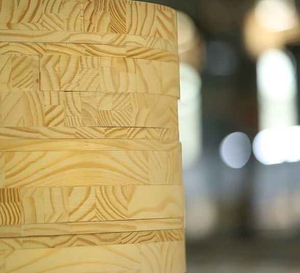A stack of rounded wooden disks with intricate wood grain patterns.