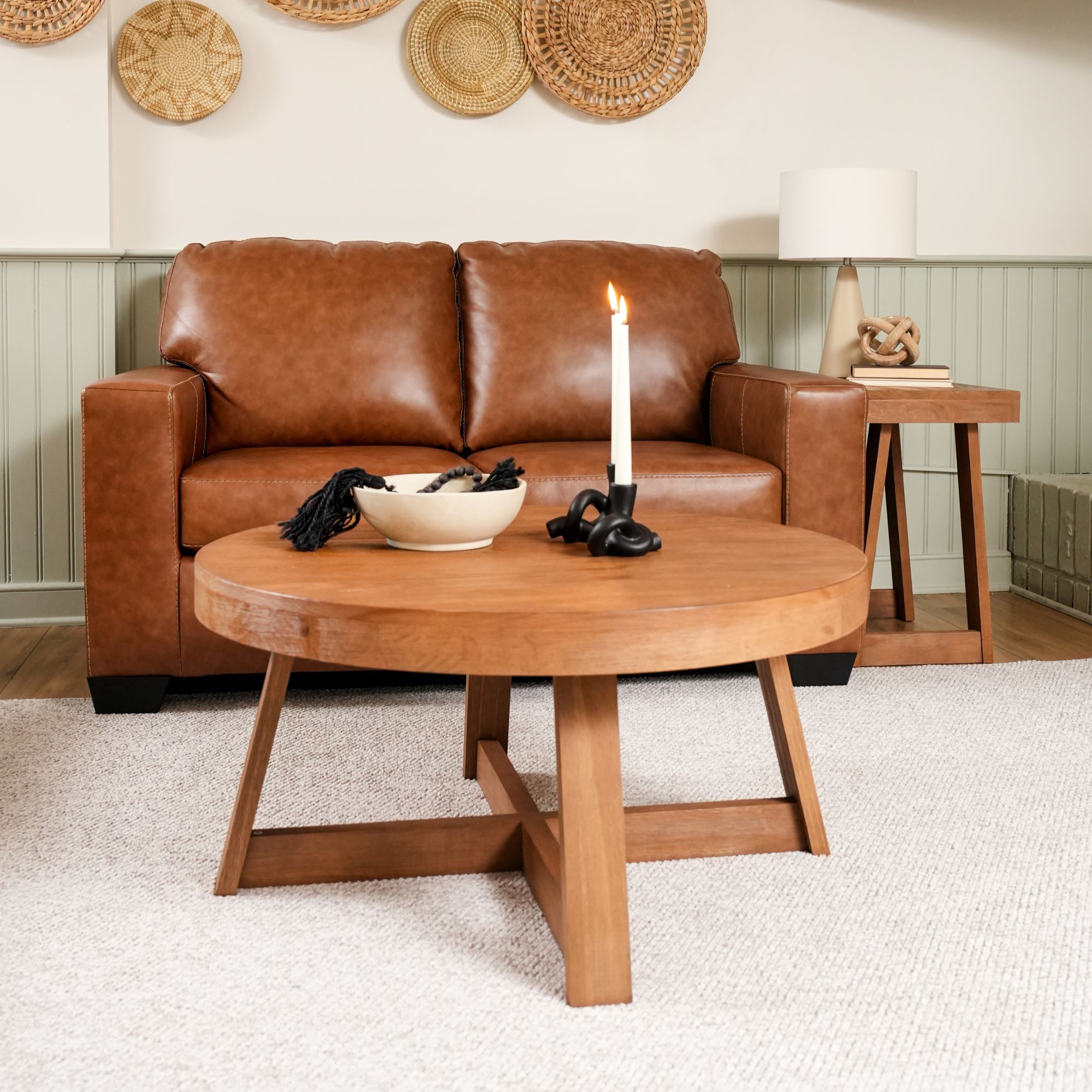 Brown leather sofa with a wooden coffee table in a living room setting.