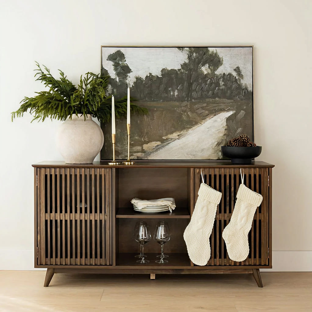 Light decor room with a modern, walnut entryway stand with white stockings for holiday season.