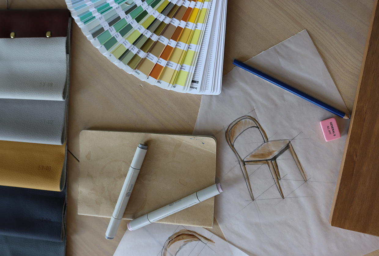 A sketch of a dining chair next to markers, color swatches, a pencil and eraser, and fabric samples.