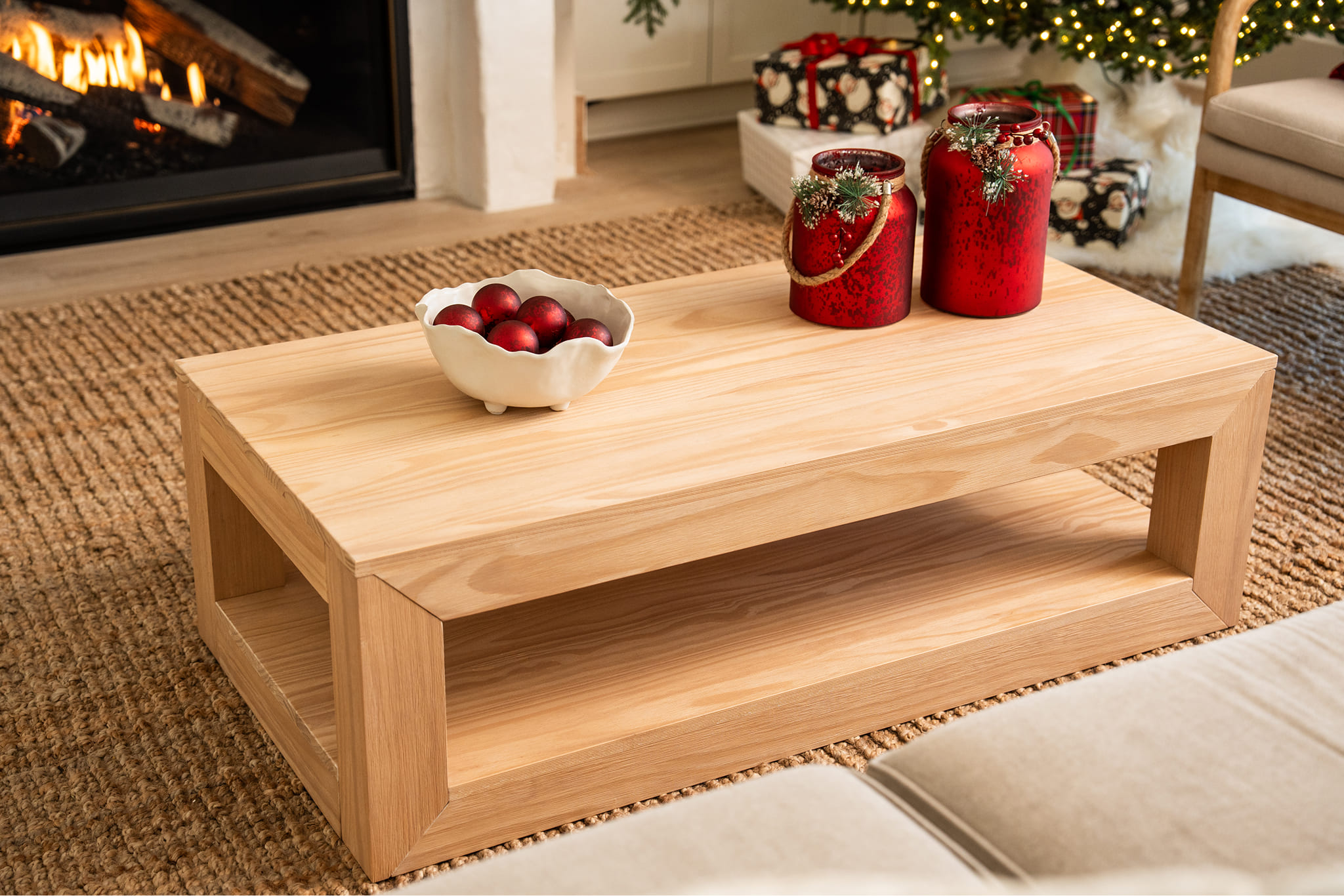 Wooden dining table set with chairs and bench on a patterned rug.
