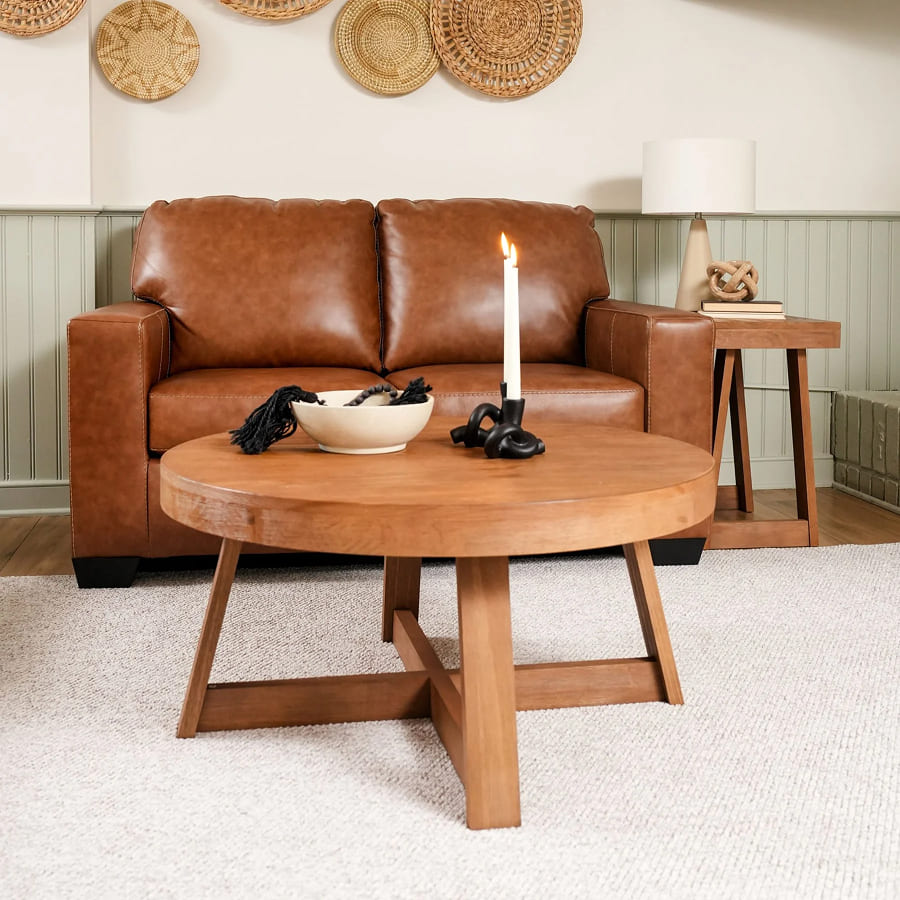 Brown leather sofa with a wooden coffee table in a living room setting.