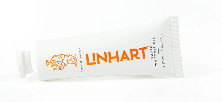 White tube of Linhart tooth whitener gel with orange logo.