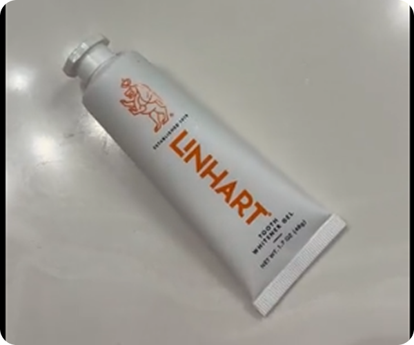 A tube of LINHART toothpaste on a light surface.