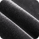A close-up of dark, shimmery, textured fabric arranged in diagonal folds.