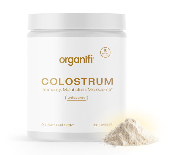 Container of Organifi Colostrum supplement with powder on the side.