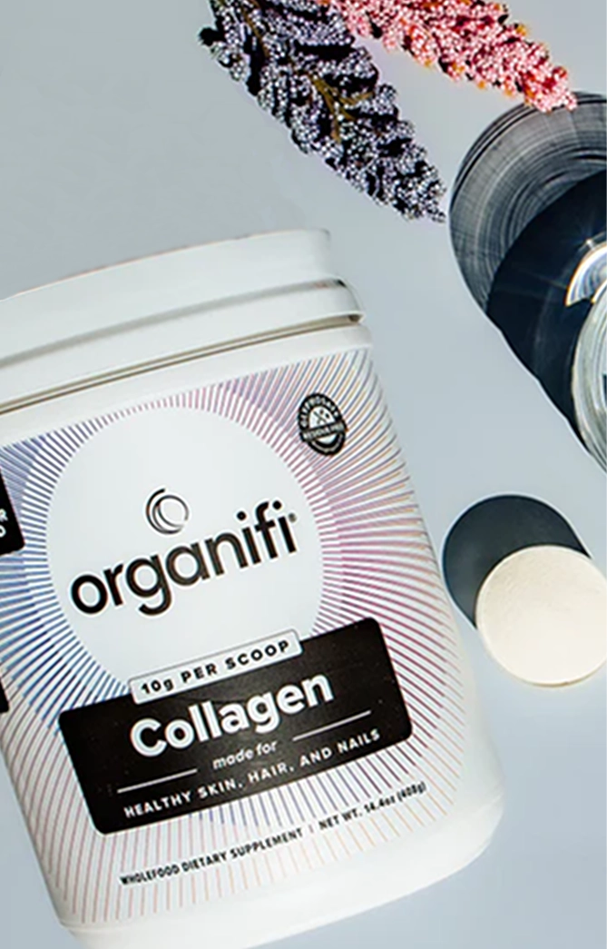 Container of Organifi collagen powder with flowers and a scoop.