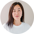 Portrait of a woman with long hair wearing a white shirt.