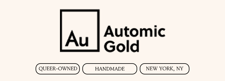 The logo for Automic Gold, with tags below reading Queer-Owned, Handmade, and New York, NY.