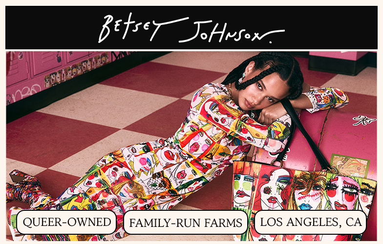 A woman in a colorful patterned jumpsuit lies on a checkered floor next to a matching bag and pink lockers.