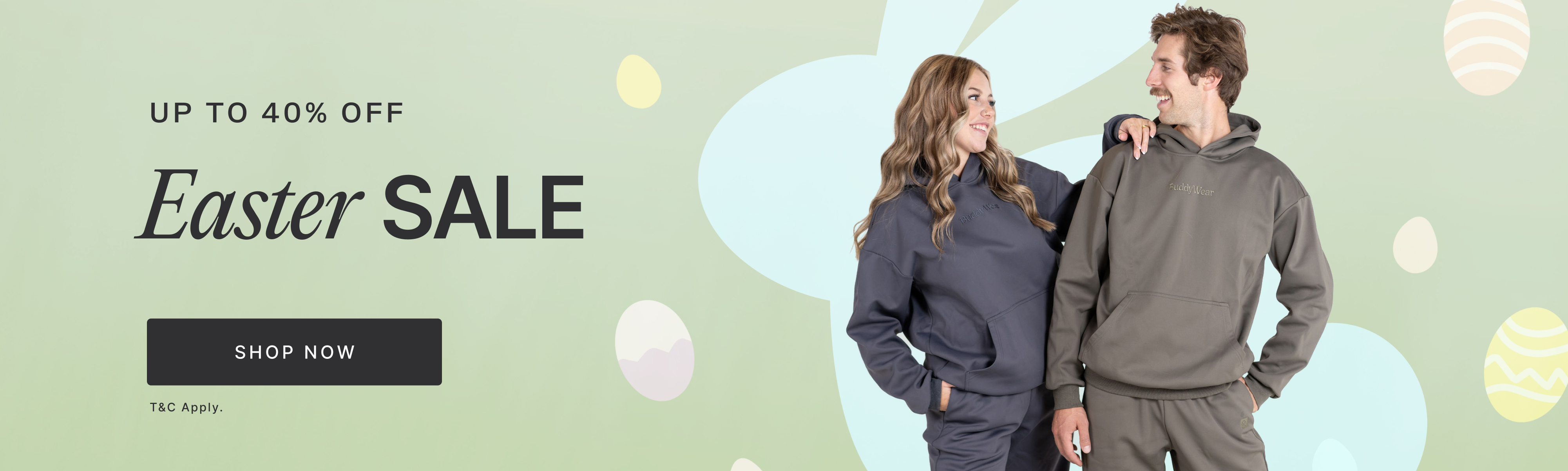 A man and woman in matching tracksuits smile at each other on an Easter Sale banner.