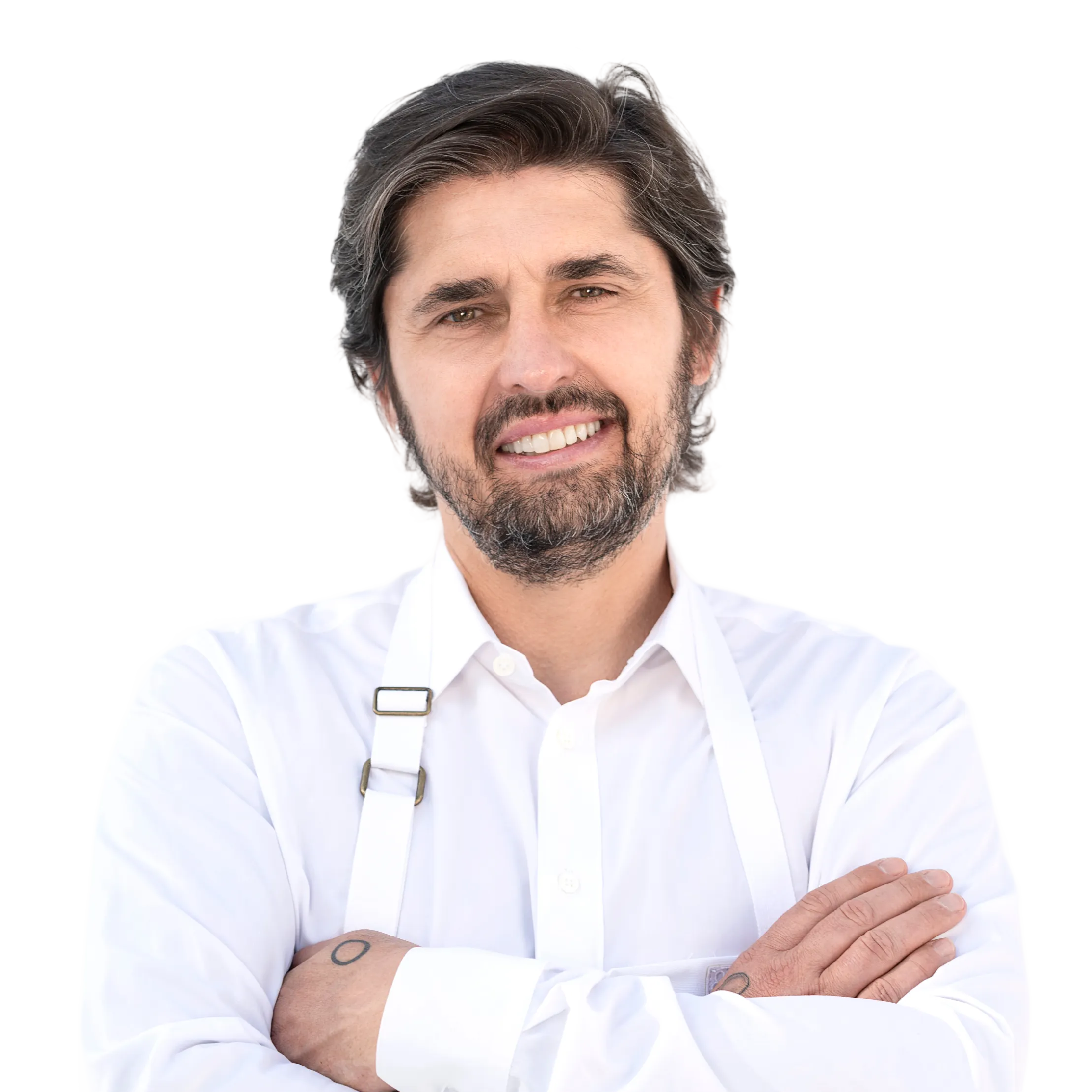 Man in white shirt with crossed arms, smiling at the camera.