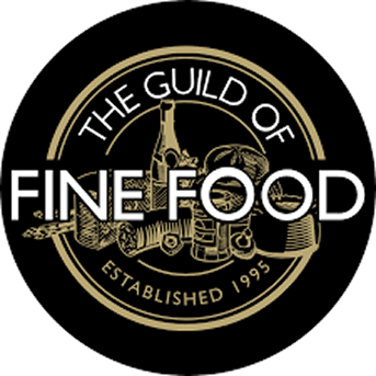 The Guild of Fine Food logo, a black circle with gold illustration and white text, established 1995.