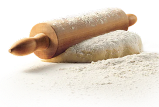A wooden rolling pin rests on a mound of dough, both dusted with flour against a white background.