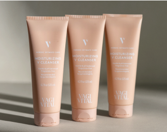 Three tubes of moisturizing cleanser on a neutral background.