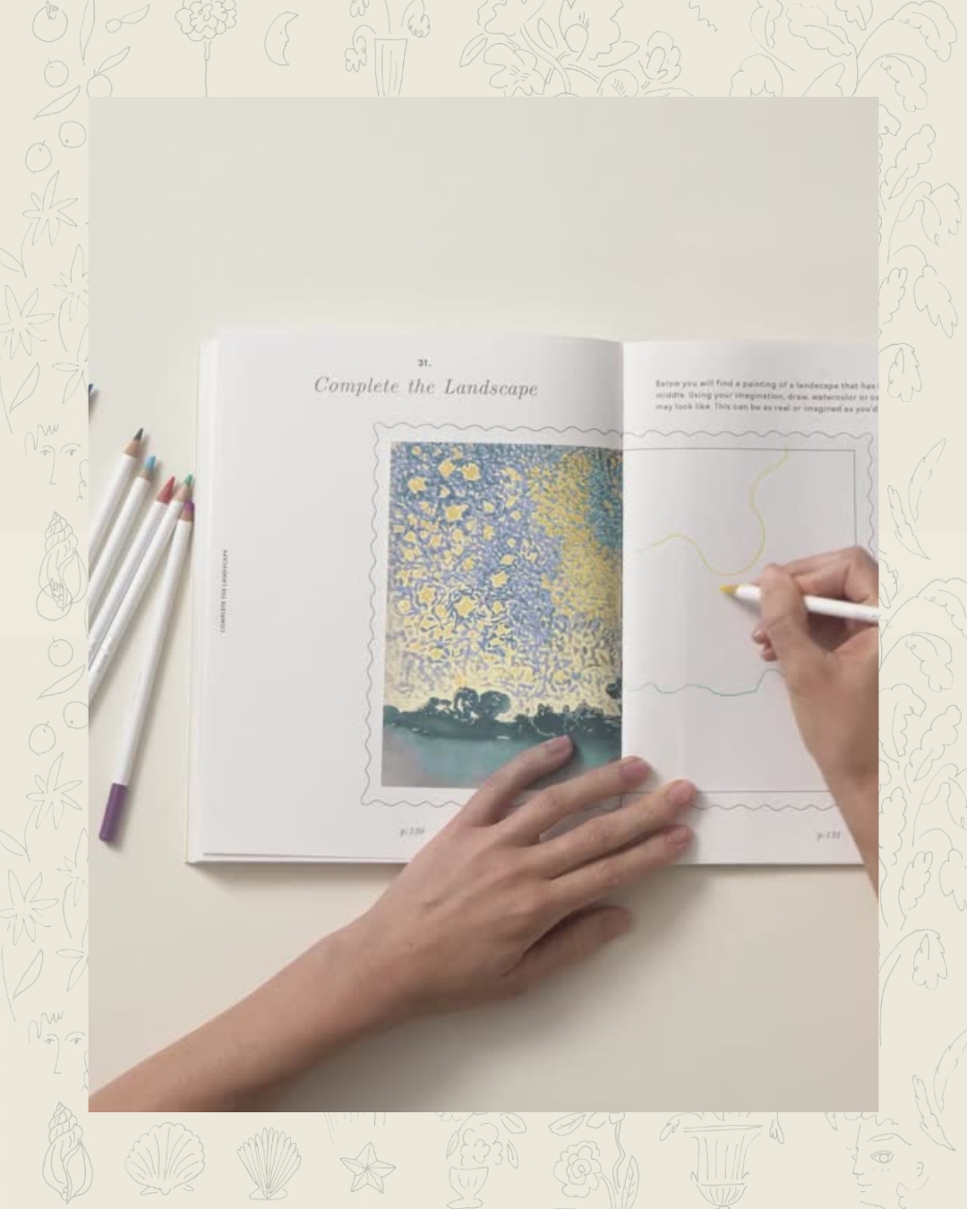 Person drawing in a landscape coloring book with colored pencils.