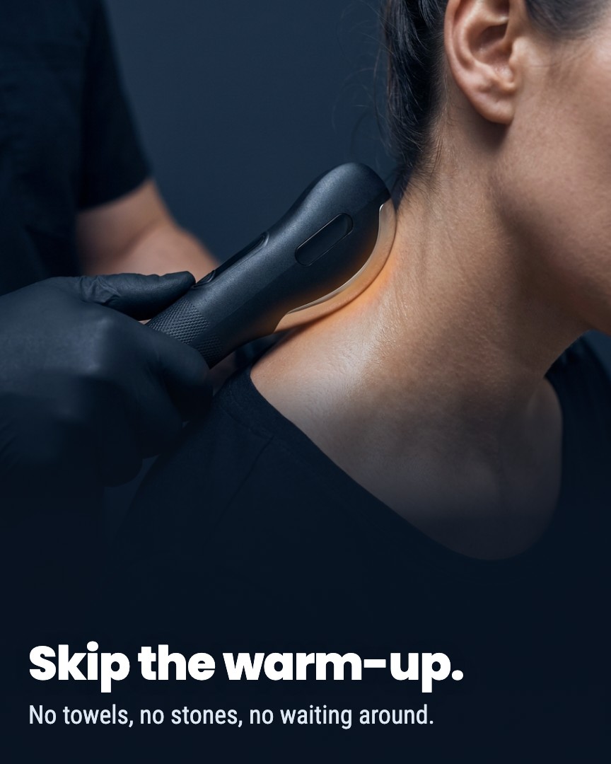 A person in black gloves uses a handheld, heated massage tool on another person's neck and shoulder.