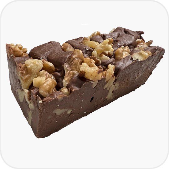 Chocolate fudge with ingredients on a marble countertop.