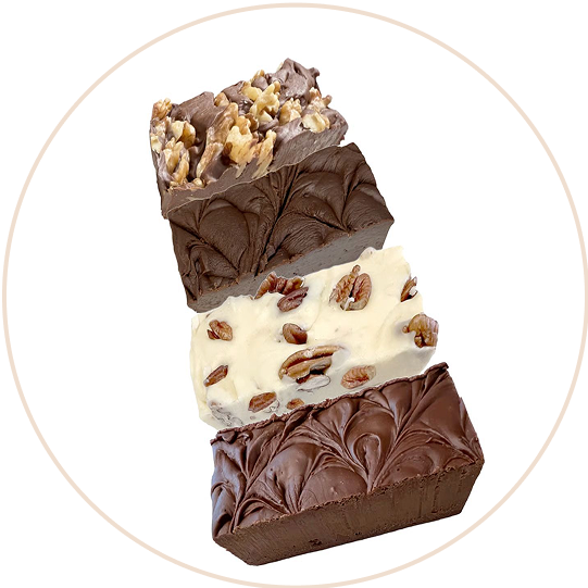 Four stacked pieces of fudge with nuts and swirled patterns.