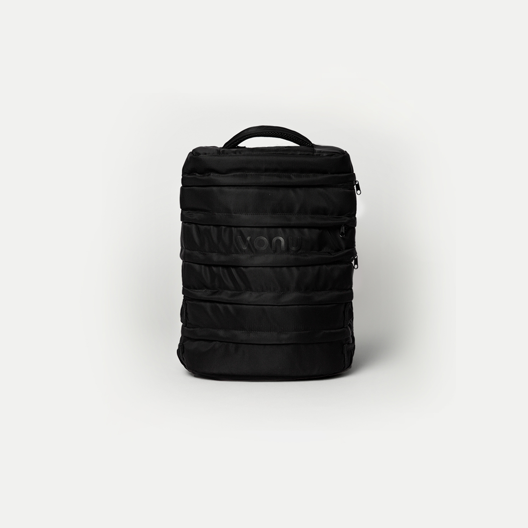 Black backpack with multiple zippers, on a plain white background.