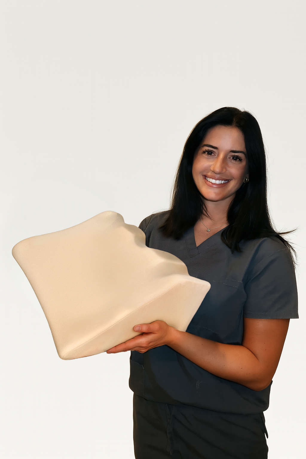 Person holding a large, beige, contoured foam object, smiling.