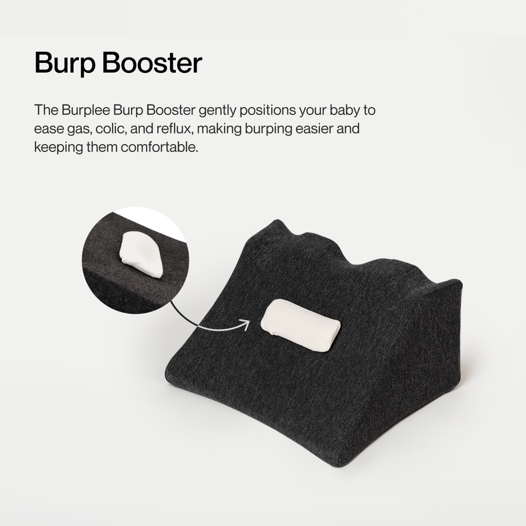 Dark gray wedge-shaped pillow with a white patch, labeled 'Burp Booster.'