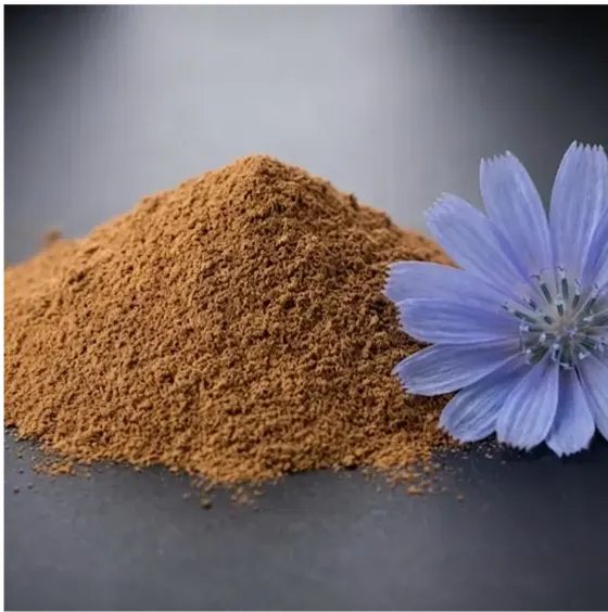 Pile of brown powder with a purple flower beside it.