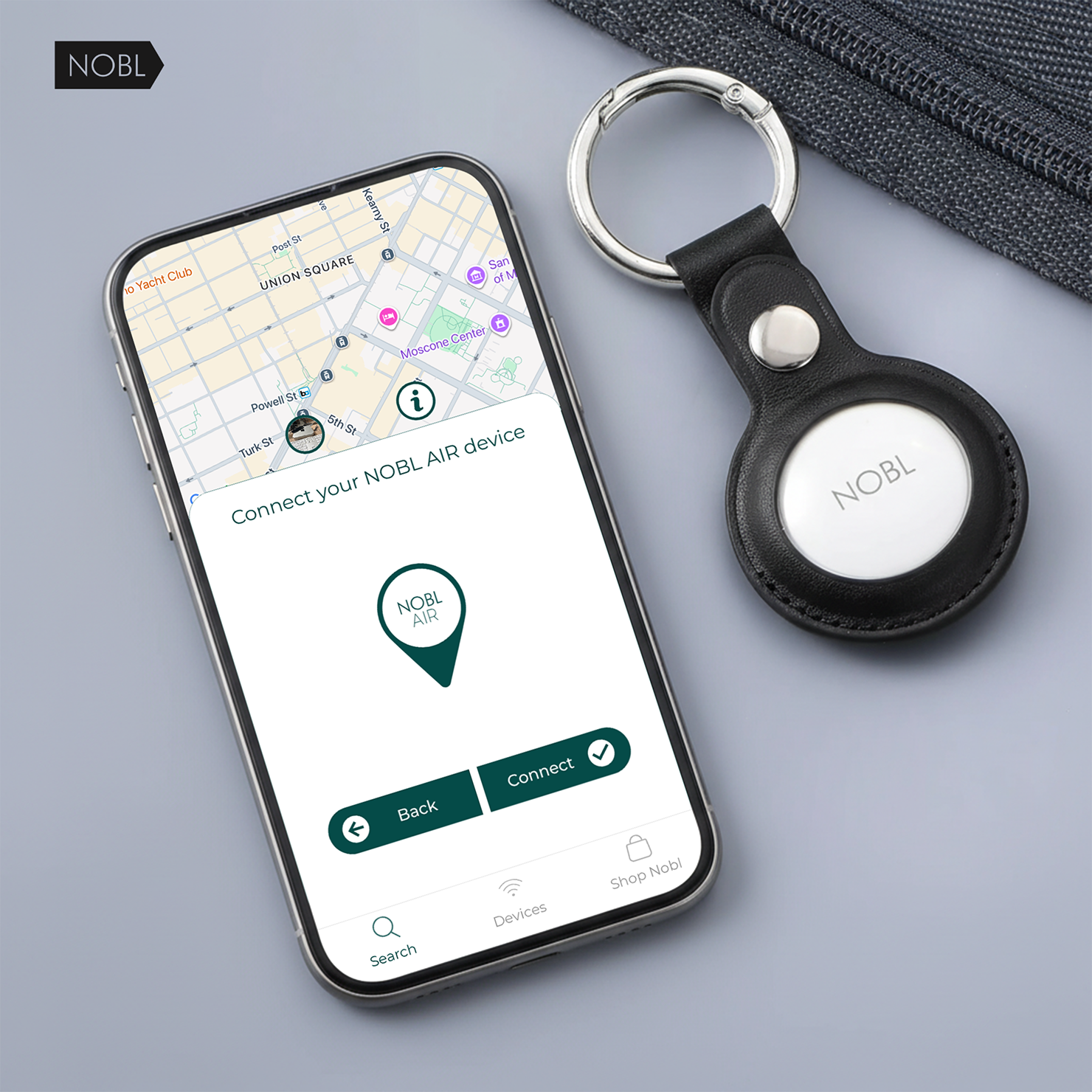 A smartphone showing the NOBL AIR app connection screen next to a NOBL tracking tag on a keychain.