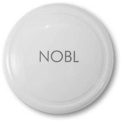 A white, circular disc with the word NOBL printed on it in a grey, sans-serif font.