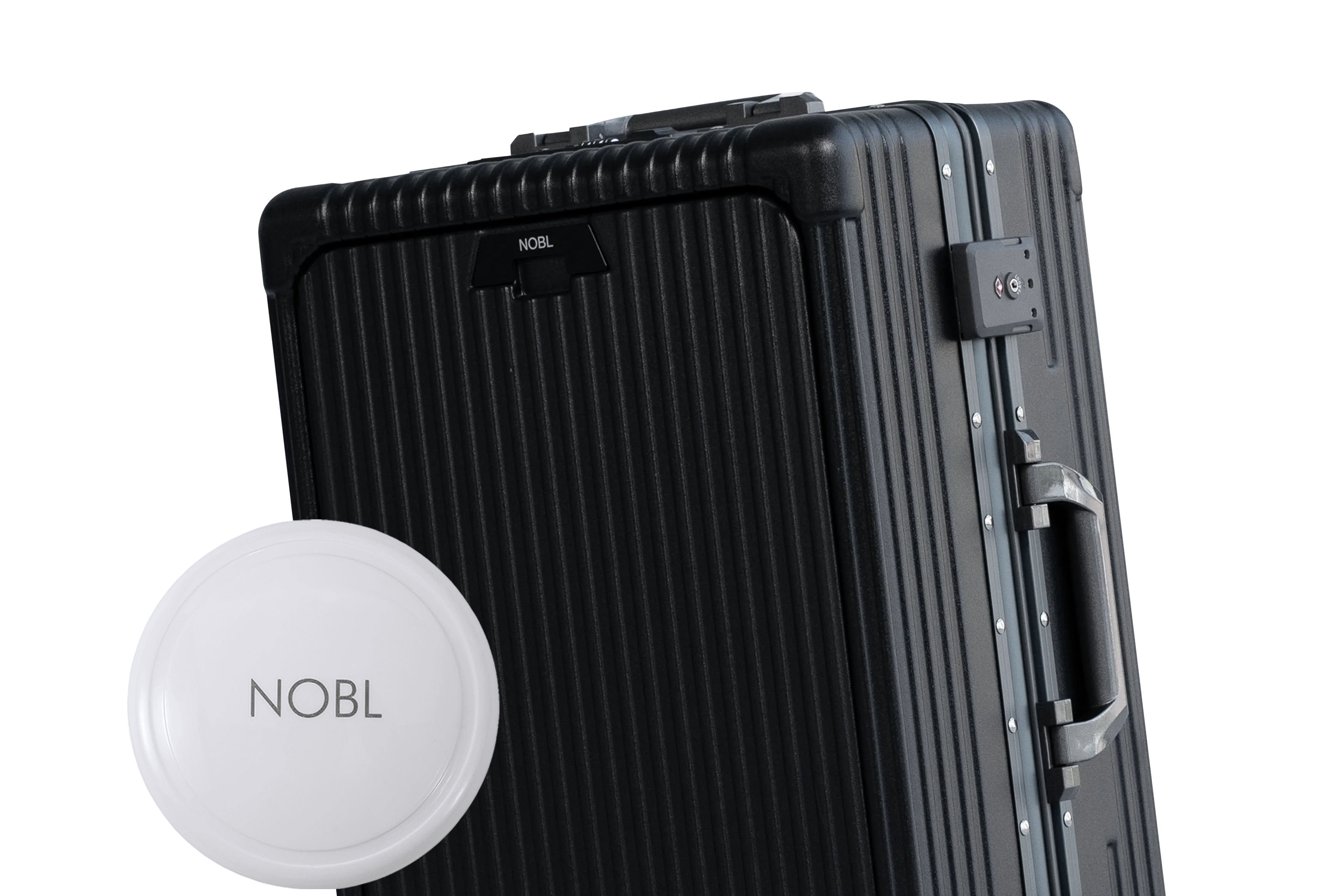 A close-up of a black, ribbed suitcase and a white circular tag, both branded with the name NOBL.