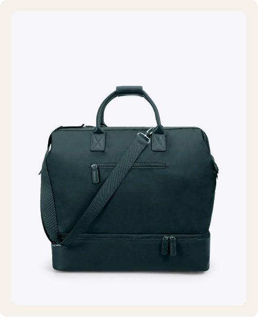 A dark green travel bag with a shoulder strap and a separate zippered compartment on the bottom.