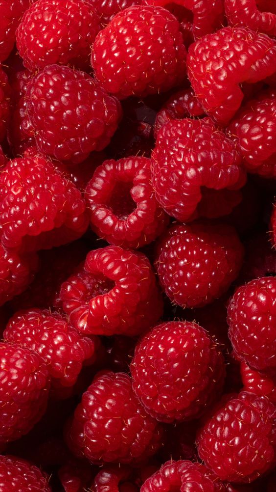 A close-up overhead shot of a pile of fresh, ripe raspberries.