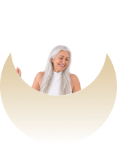 A smiling woman with long grey hair behind a light tan crescent-shaped graphic.