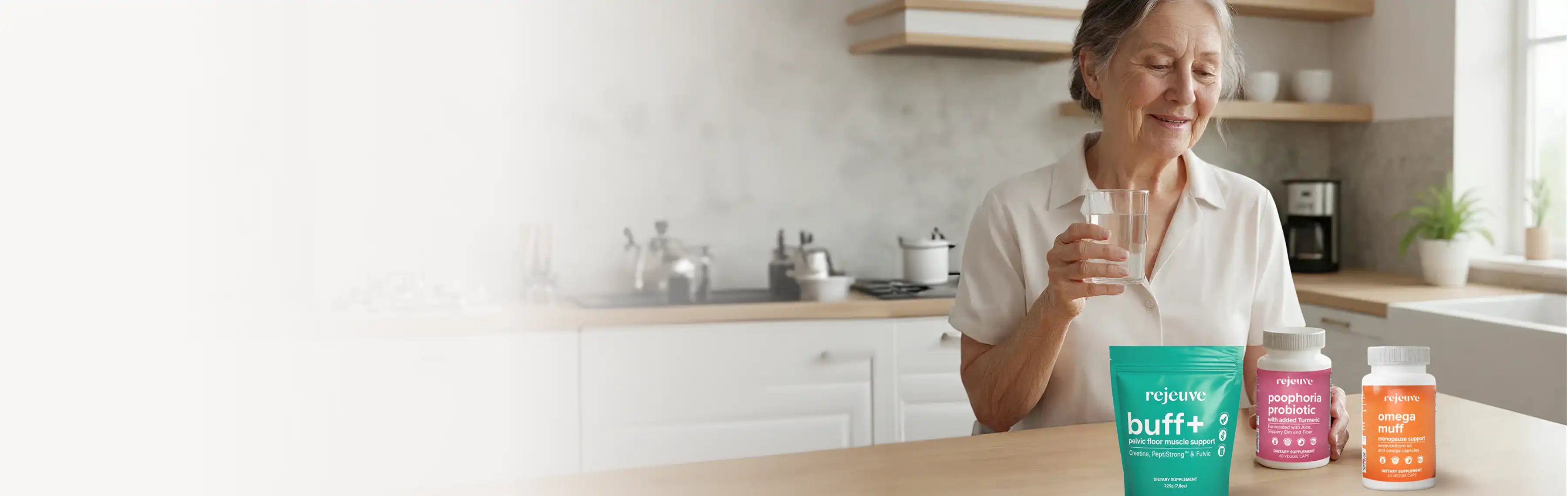 Smiling woman holding a glass of water next to three supplement bottles.