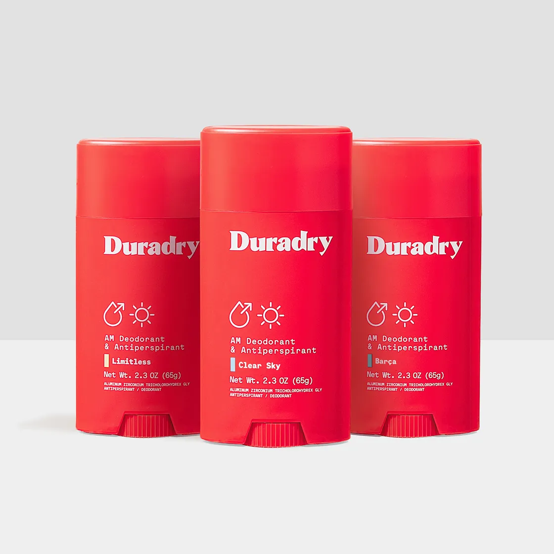 Three red sticks of Duradry AM Deodorant & Antiperspirant in various scents against a light grey background.