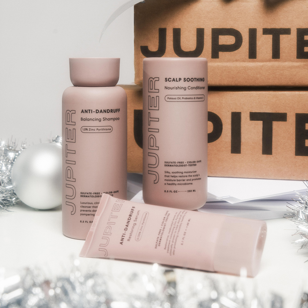 Jupiter hair care products with holiday-themed decorations in the background.