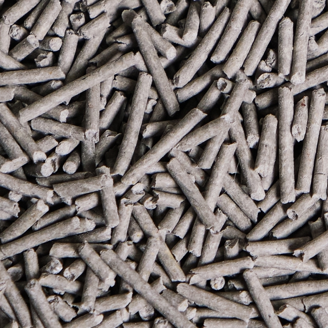 A close-up overhead shot of a pile of gray, cylindrical pellets.