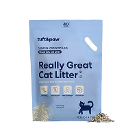 A blue bag of Tuft & Paw's 'Really Great Cat Litter' with small piles of the litter next to it.