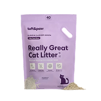 A purple bag of Tuft & Paw Really Great Cat Litter on a black background.