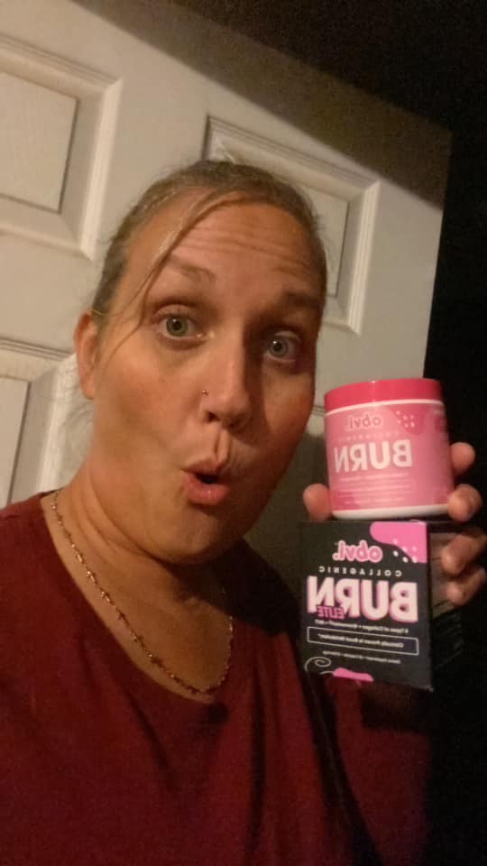 Person holding a pink product container, looking surprised.