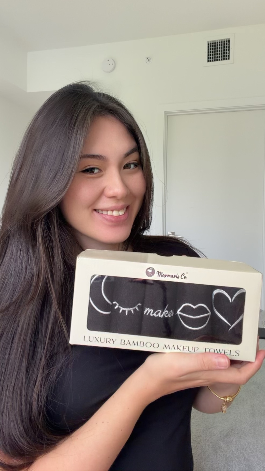 Person holding a box of luxury bamboo makeup towels.