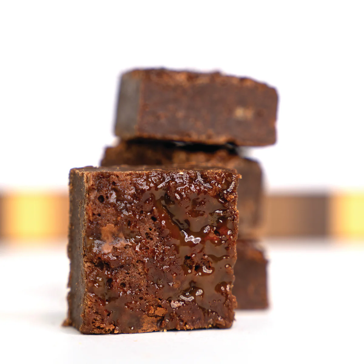 Close-up of stacked chocolate brownies with a glossy, rich texture.
