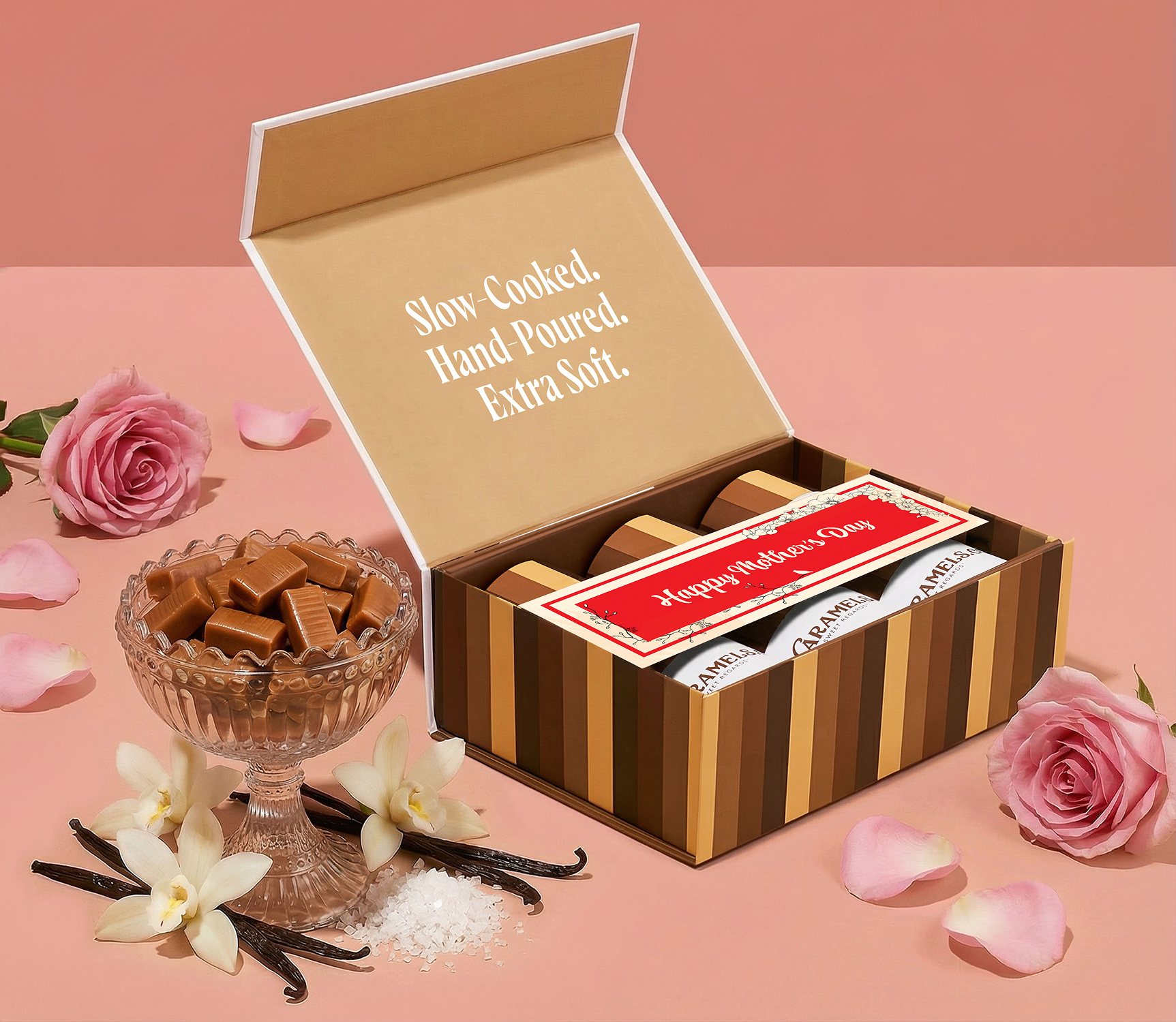 A 'Happy Mother's Day' caramel gift box next to a glass dish of caramels, roses, and vanilla.