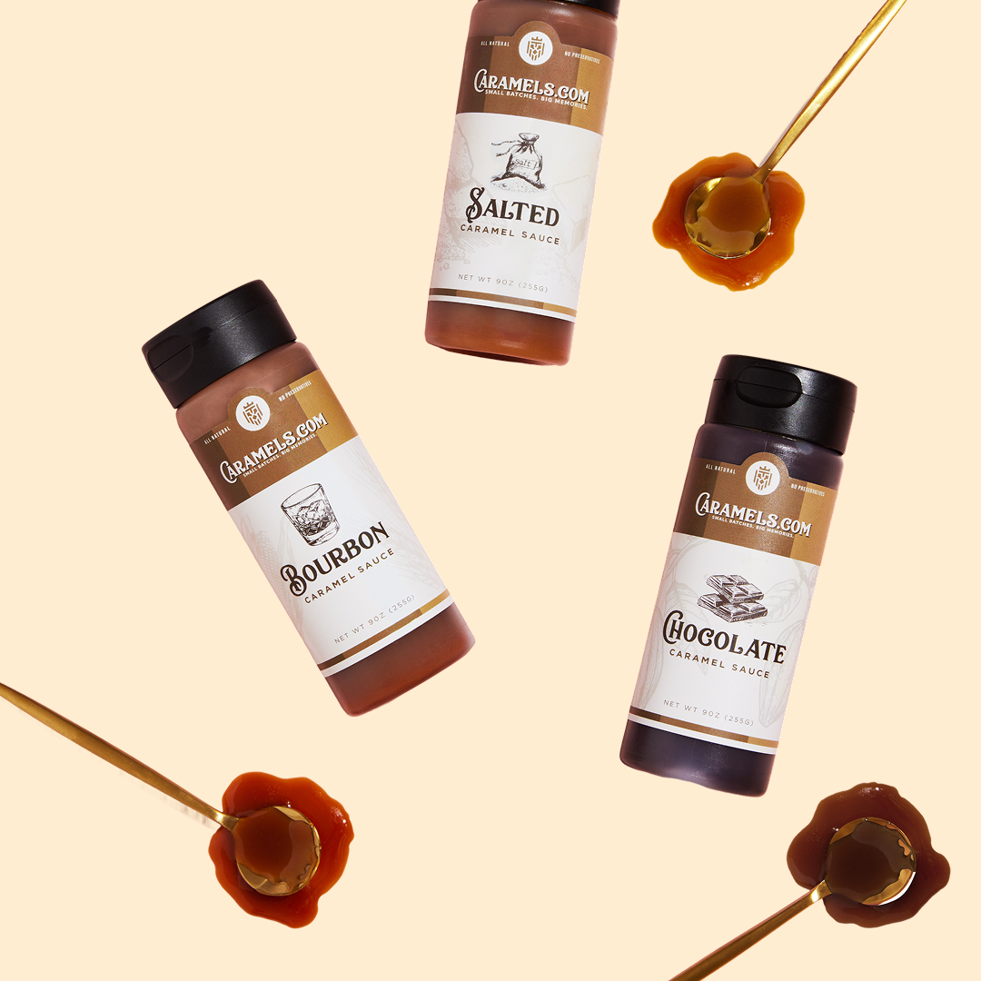 Three caramel sauce bottles with spoons of caramel on a light background.