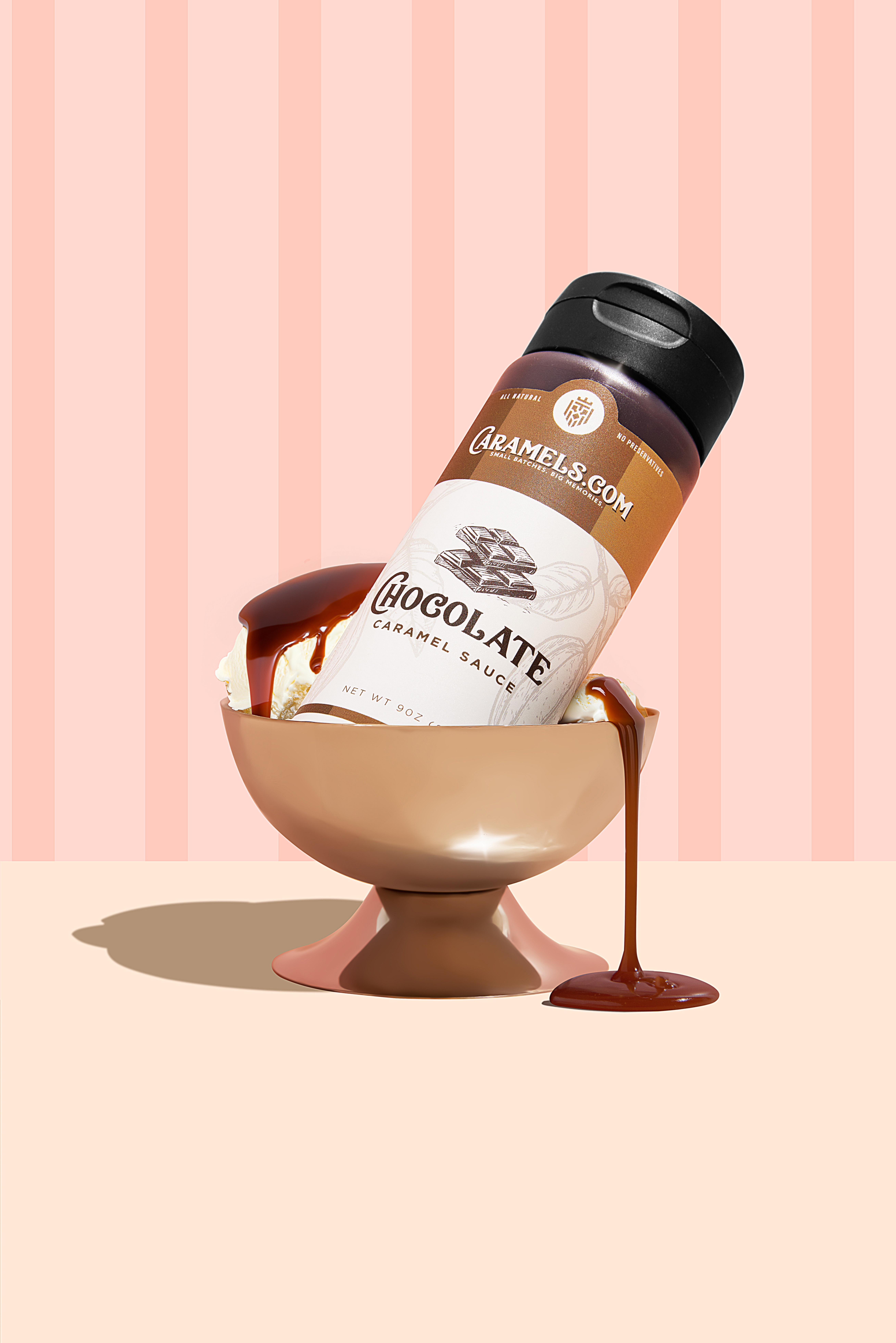 Chocolate caramel sauce bottle in a bowl, dripping onto surface.