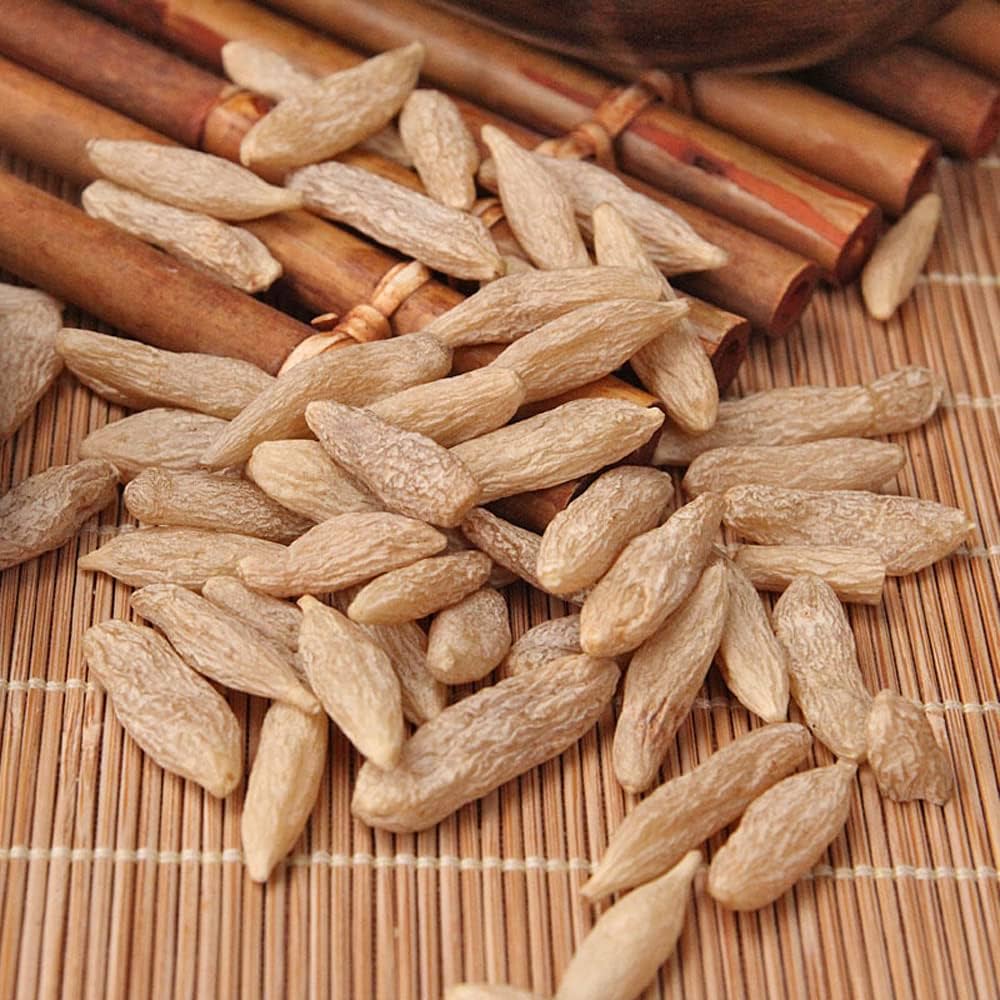 A pile of dried seeds on a bamboo mat.